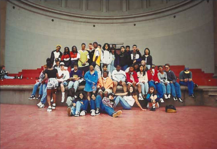 Students posing on stage looking at camera